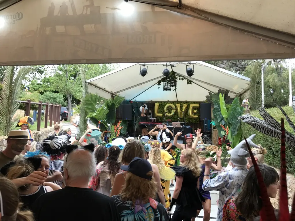 Audience gathered beneath a festival pavilion for a live performance