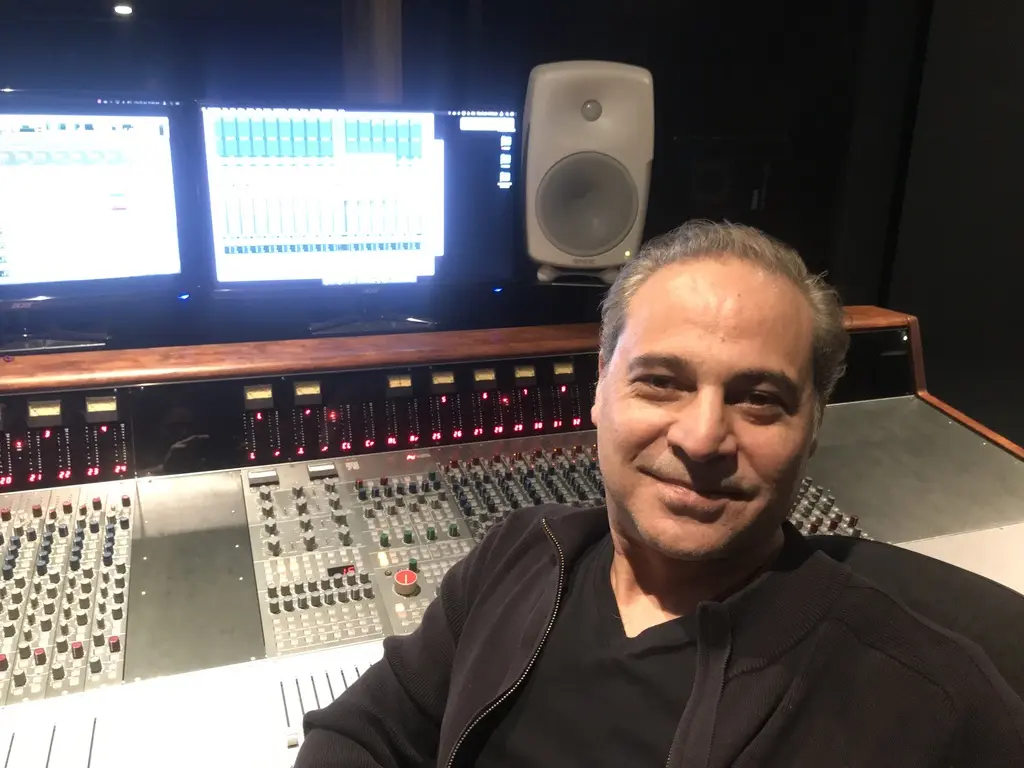 Sam Cutri seated at a large-format recording console